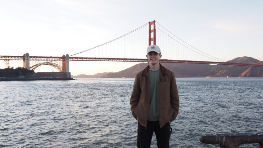 Person in front of Golden Gate Bridge from San Francisco waterfront